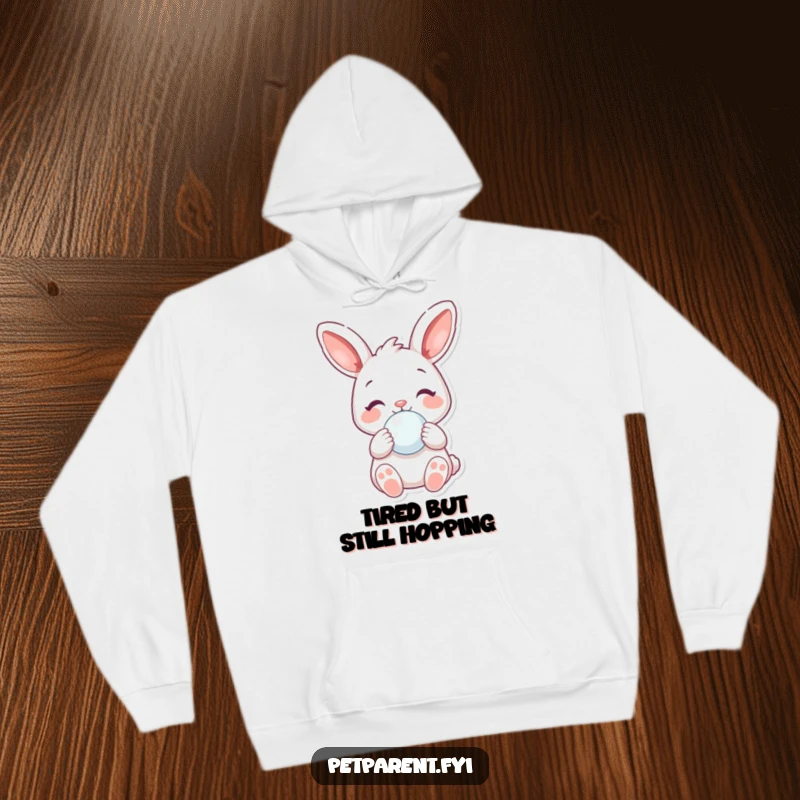 Funny Hoodie: A cheerful rabbit holds a baby pacifier, depicting a funny and gentle moment of care.
